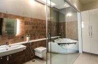 A full glass wall divides the the dressing area from the toilet in the son's bedroom.